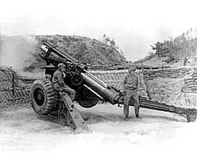 Photo:  Brigadier General Kenneth S. Sweaney, CG, X U.S. Corps Artillery, pulls the lanyard on the howitzer to fire the 150,000th round of ammunition used by men of Battery B, 955th Field Artillery Battalion, U.S. Eighth Army. 