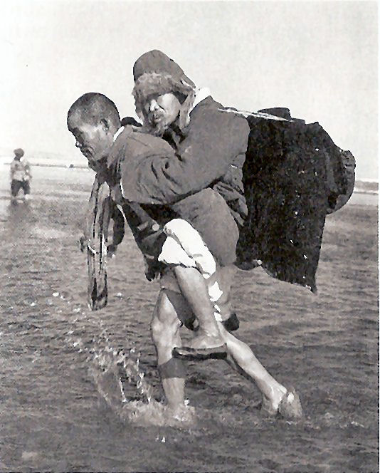  Aged Refugee Carried Across the Han River south of Seoul, January 1951  (right click, view image to see actual photo)