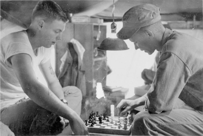Herb playing chess with another corpsman