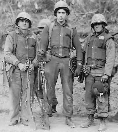 Marines with weapons captured in raid on Hill 15, Detroit