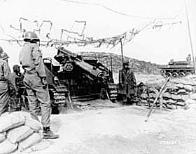 Photo: Personnel of No. 4 gun, Battery "B", 999th Armored Field Artillery Battalion, U.S. Eighth Army, fire on enemy positions.