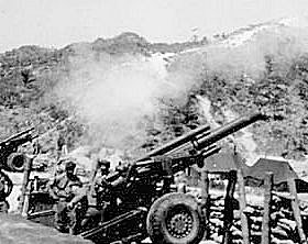 Photo:  Men of Battery B, 75th Field Artillery Battalion, U.S. Eighth Army, fire 155-mm howitzers at Communist positions, near Kumwha, Korea.
