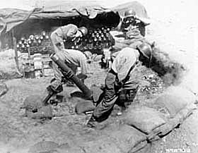 Photo: A 4.2-inch mortar crew of the Heavy Mortar Company, 179th Regiment, 45th U.S. Infantry Division, fires on Communist positions, west of Chorwon, Korea.