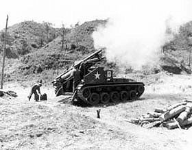 Photo:  A 155-mm howitzer acting as "base gun" for Battery A, 92nd Armored Field ArtilleryBattalion, U.S. Eighth Army, firing adjusting rounds near Kumhwa, Korea.