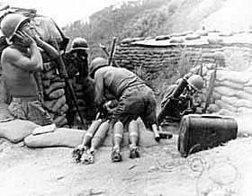 Photo:  Members of the 81-mm Mortar Platoon, Co. D, 2nd Battalion, 5th Infantry Regiment, U.S. Eighth Army, blast Communist positions in Punchbowl, Korea.