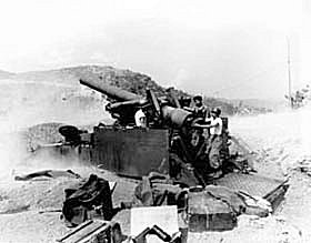 Photo:  A gun crew firing an eight-inch self-propelled howitzer at Communist hill positions after receiving a fire mission from Co. A, 1st Battalion, 5th Infantry Regiment, U.S. Eighth Army, west of Punchbowl.