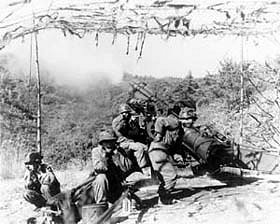 Photo:  A gun crew of the 88th Field Artillery, ROK Army, fires a 155-mm howitzer at Communist positions.