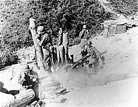 Photo:  Infantrymen of the Heavy Mortar Co., 1st Platoon, 35th Infantry Regiment, 25th U.S. Infantry Division, fire the 4.2-inch Heavy mortar.