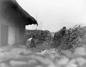Photo:  Waiting for the counterattack, these men of the 19th Infantry Regiment, 24th Division, dig in.