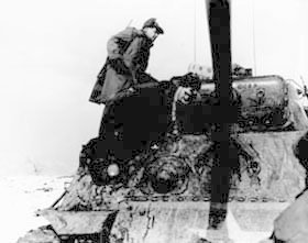 Photo:  A soldier of the 35th Regiment, 25th U.S. Infantry Division, goes aboard a tank to be evacuated to rear areas after he was wounded by mortar fire.