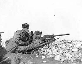 Photo:  Men of Co. K, 35th RCT, 25th Division, fire a light machine gun.