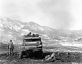 Photo:  Men of Battery B, 15th AAA Battalion, 7th Infantry Division, fire quadruple .50 caliber machine guns.