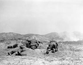 Photo:  Elements of the 15th RCT, 3rd Infantry Division, fire upon Communist dug-in positions.