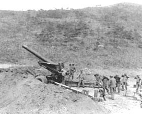 Photo:  Men of Battery A, 17th Field Artillery Battalion, EUSAK, cover their ears as unit leader gives the signal for firing the 8-inch howitzer.