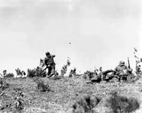 Photo:  Lieutenant Ralph Barnes of Arlington, Va., platoon leader, 1st Platoon, Co. C, 15th Infantry Regiment, 3rd Infantry Division, throws a hand grenade.