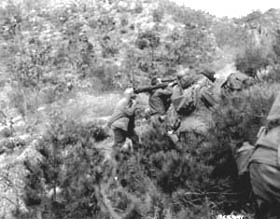 Photo:  A 57-mm recoilless rifle team opens fire at a Chinese position.