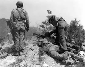Photo:  A machine gun crew gives supporting fire to UN troops as they withdrew from Hill 412.