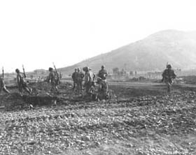 Photo:  A squad of the 3rd Ranger Co., 3rd Infantry Division, moves out of assembly area.