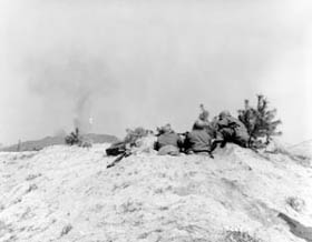 Photo:  A .50 caliber machine gun gives covering fire for Greek troops of the 7th Cavalry Regiment, 1st Cavalry Division.