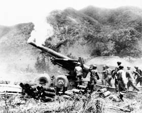 Photo:  Cannoneers of Battery A, 17th Field Artillery Battalion, U.S. Eighth Army, Reload their 8-inch howitzer.