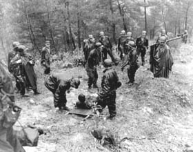 Photo:  A wounded man of the 17th Infantry Regiment, 7th Division, is evacuated from Hill 657.