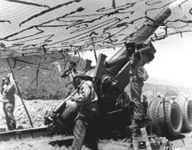 Photo:  An 8-inch howitzer crew of Battery A, 96th Field Artillery Battalion, fires at Communist positions near Yanggu, Korea.