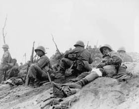 Photo:  Cpl. Sam Ayala of Niles, Calif., Co. L, 7th RCT, U.S.3rd Infantry Division, waits for medical evacuation from Hill 717.