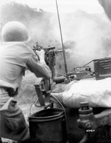 Photo:  Sgt. Douglas D. Tompkins of Jud, North Dakota, Tank Company, 5th RCT, 24th U.S. Infantry Division, fires a .50 caliber machine gun.