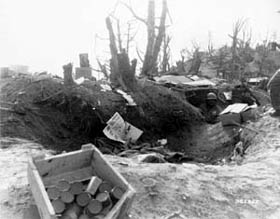 Photo:  Showing the entrance to his bunker at the edge of crater caused by an enemy mortar shell is Corporal George C. Brown, Boston, Massachusetts, Company L, 3rd Battalion, 7th Cavalry Regiment, 1st U.S. Cavalry Division. 