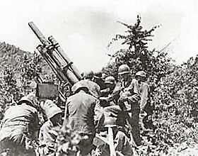 A gun crew checks their equipment near the Kum River