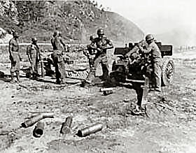 American troops blasting Yongdok with their105-mm howitzer.