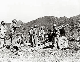 Artillery gun crew waits for the signal to fire on the enemy, somewhere in Korea.
