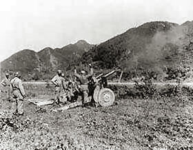 American artillery firing on Communist-led North Koreans, somewhere in Korea.