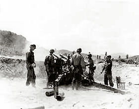 Men of Battery B, 61st Field Artillery, 1st Cavalry Division, fire across the Naktong River at postions of the Communist-led North Korean invaders. They are, L. to R., Pvt. Alvin Essary of Tuscalossa, Ala.; Pvt. Miller T. Young of Avonmore, Pa.; Pvt. Harvey L. Lewis of Porterville, Calif.; Pvt. Abel Saunders of Venton, Va.; and Cpl. Lester Mortz of Sheridan, Oregon.