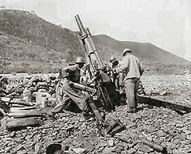Men of Battery A, 159th Field Arillery Battalion, fire a 105-mm howitzer in an indirect firing mission on the Korean battle line, near Uirson.