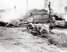 A machine gun crew fires at fleeing Communist-led North Korean targets during heavy street fighting in the captured city of Waegwan. L-r: Pfc. Austin Dela Cruz of Honolulu; Cpl. William Purdy; Pfc. Alexander Domingo of Honolulu; and platoon leader Sgt. Robert I. Muramoto of Honolulu, T.H.