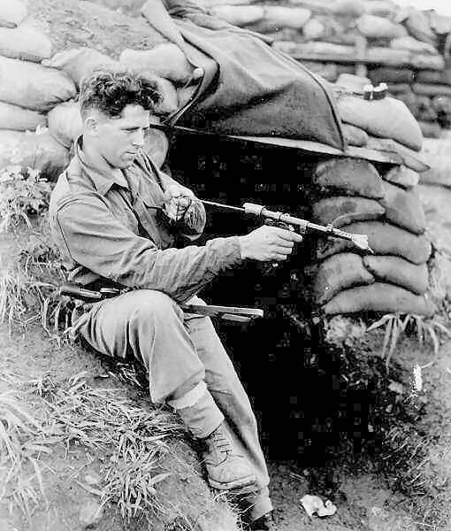 Eddie Wright, unhurt during Operation Buffalo, cleans the Aussie's friend, an Owen gun